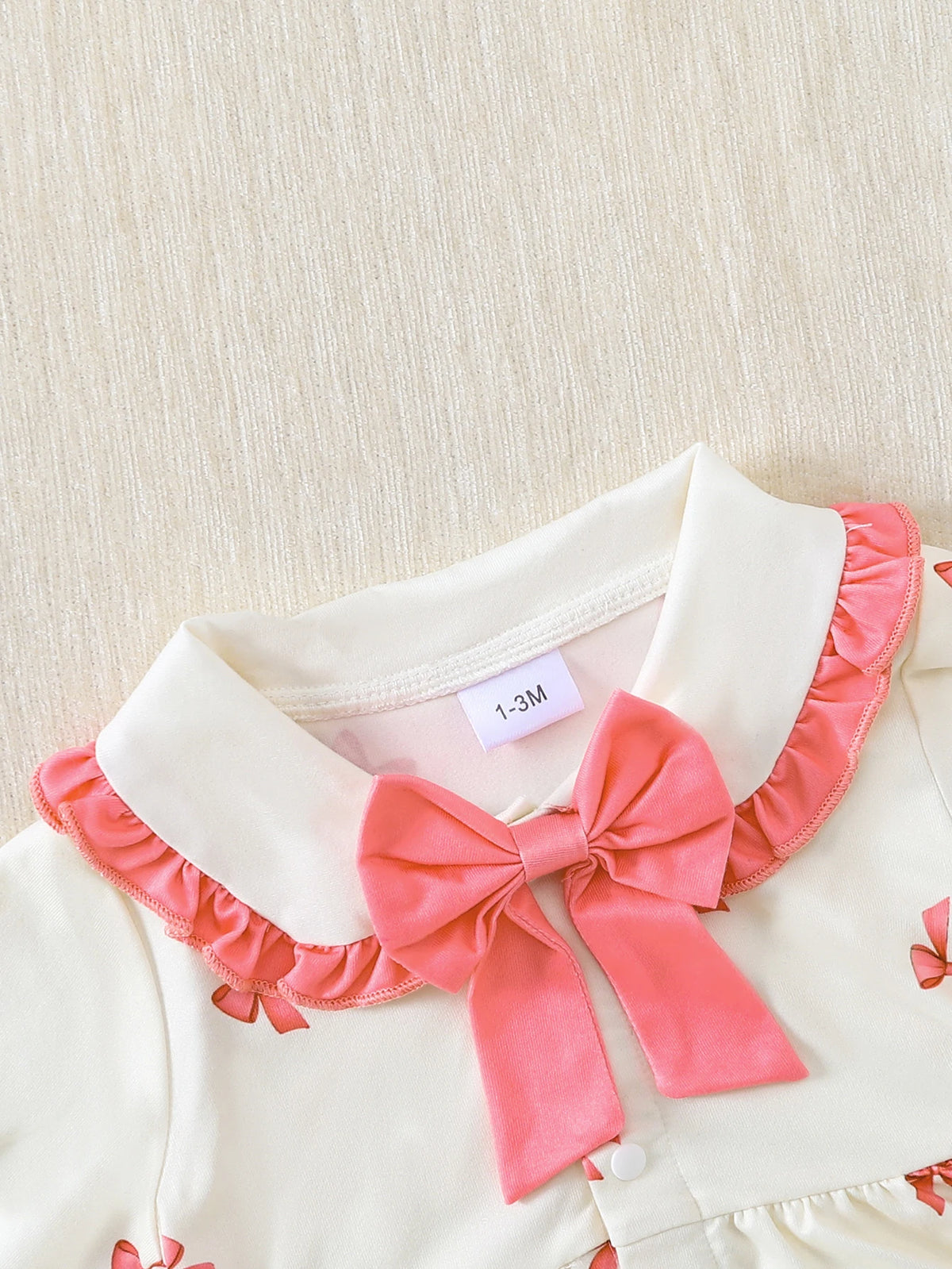 【Baby Girl Bowknot Romper】Autumn & Winter Style: Cream Base with Fuchsia Bowknot Print, featuring a doll collar and large bowkno